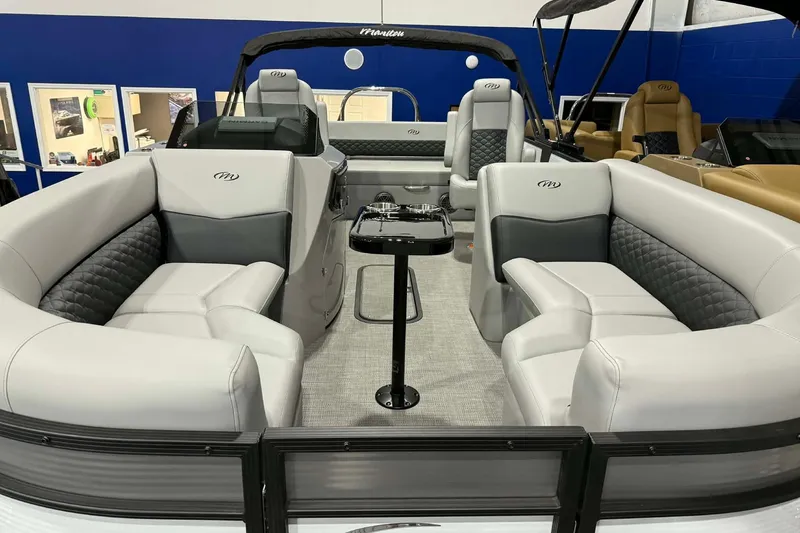 Slide: The Image of 2026 Manitou Encore SL 230 SHP pontoon boat with luxurious seating and modern design. - 3