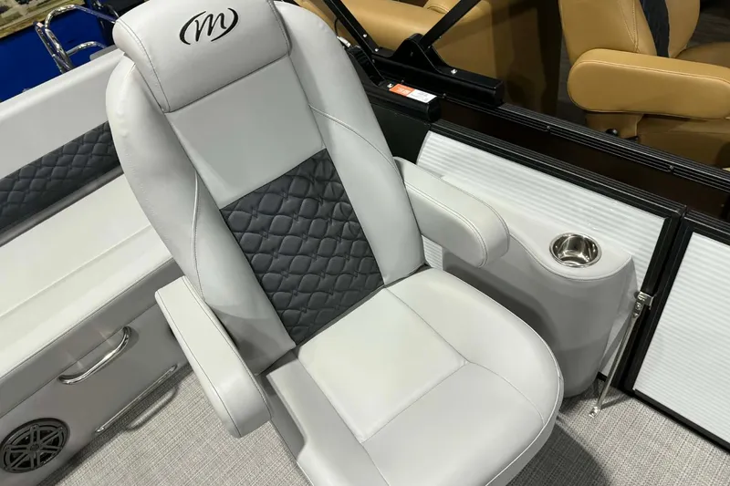Slide: The Image of Luxurious seating in 2026 Manitou Encore SL 230 SHP boat with quilted design and cup holder. - 9