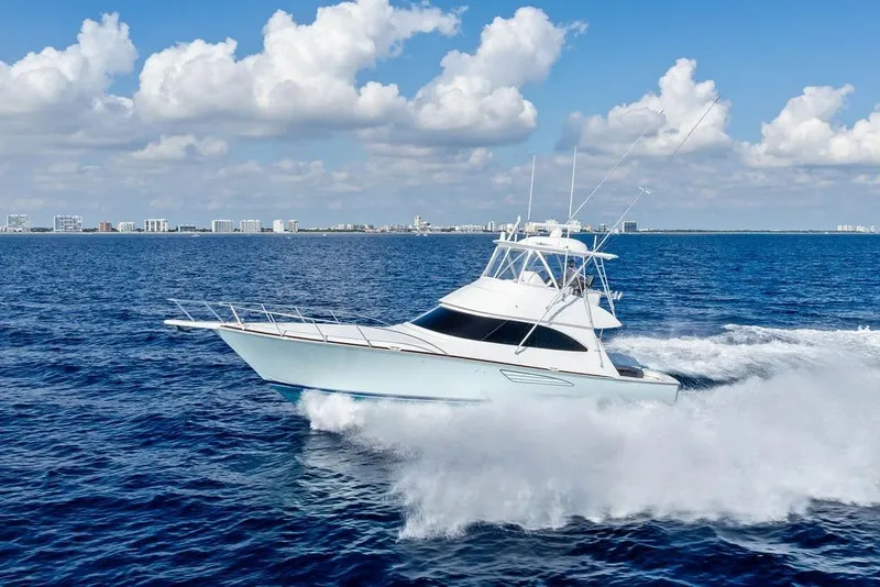 Slide: The Image of 2022 Viking 48 Convertible yacht cruising on open ocean under clear skies. - 15