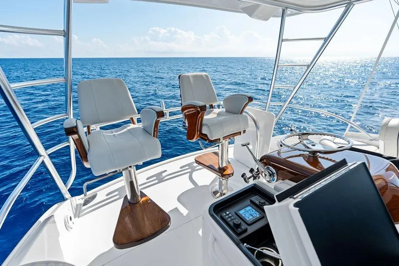 Slide: The Image of Luxury helm of 2022 Viking 48 Convertible yacht with ocean view. - 21
