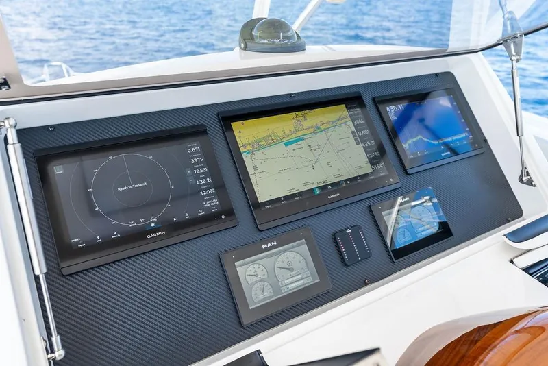 Slide: The Image of Control panel of 2022 Viking 48 Convertible yacht with navigation displays. - 26