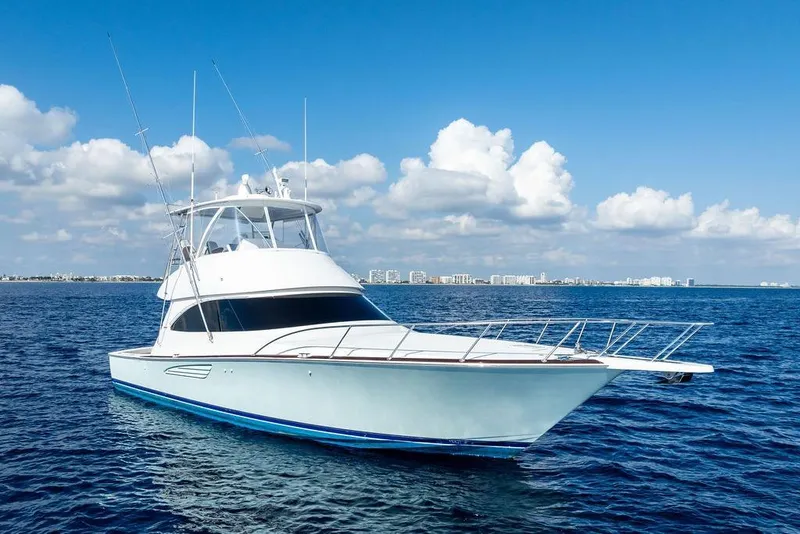 Slide: The Image of 2022 Viking 48 Convertible yacht on open sea under blue sky. - 3