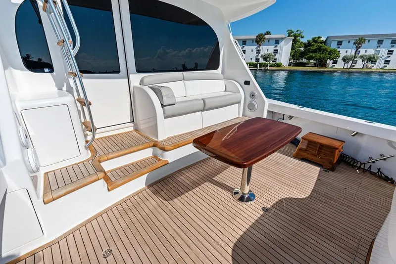 Slide: The Image of Luxurious deck of 2022 Viking 48 Convertible yacht with seating and table. - 32