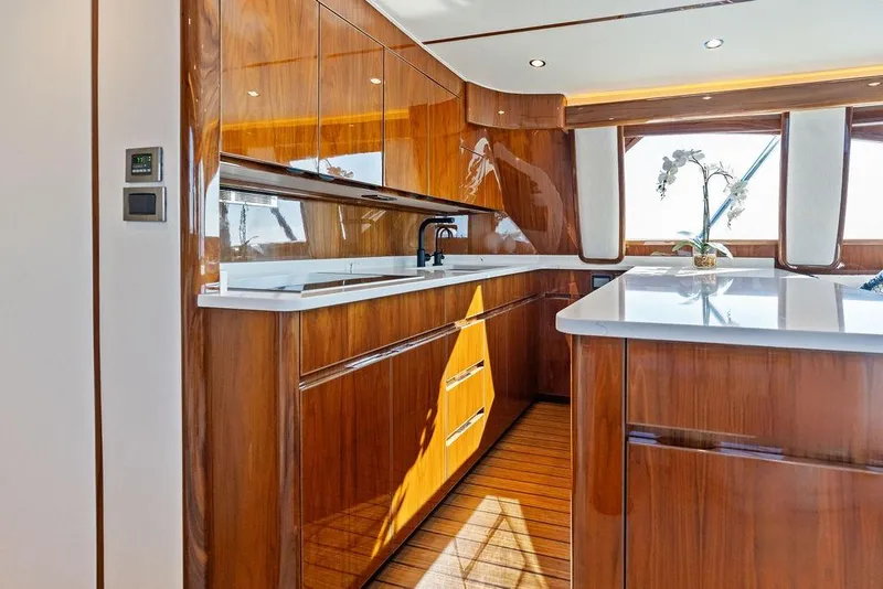 Slide: The Image of Luxurious kitchen interior of 2022 Viking 48 Convertible yacht with wood finish and modern design. - 45