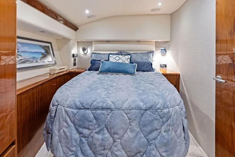 Slide: The Image of Luxurious bedroom interior of 2022 Viking 48 Convertible yacht with elegant bedding. - 51