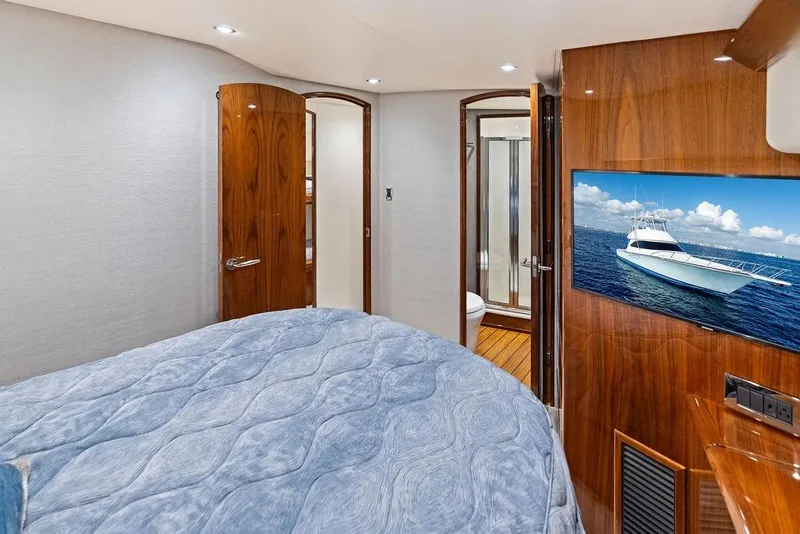 Slide: The Image of Luxurious interior of 2022 Viking 48 Convertible yacht with elegant wood finishes. - 52