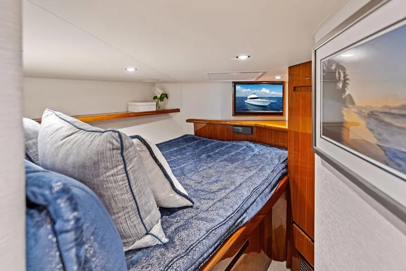 Slide: The Image of Luxurious cabin interior of 2022 Viking 48 Convertible yacht with cozy bedding and elegant decor. - 57