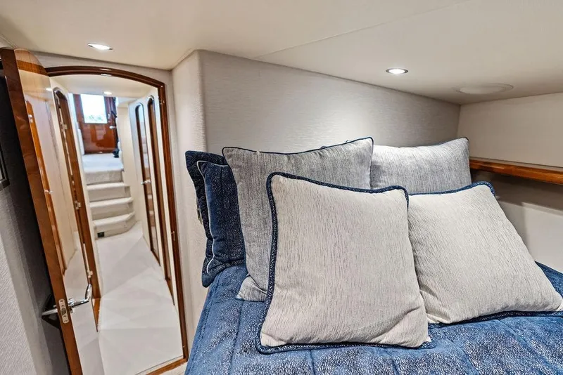 Slide: The Image of Interior of 2022 Viking 48 Convertible yacht with cozy bedding and elegant design. - 58