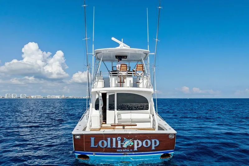 Slide: The Image of 2022 Viking 48 Convertible yacht on open sea, clear sky, rear view. - 6