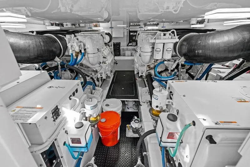 Slide: The Image of Engine room of 2022 Viking 48 Convertible yacht, featuring advanced machinery and equipment. - 64
