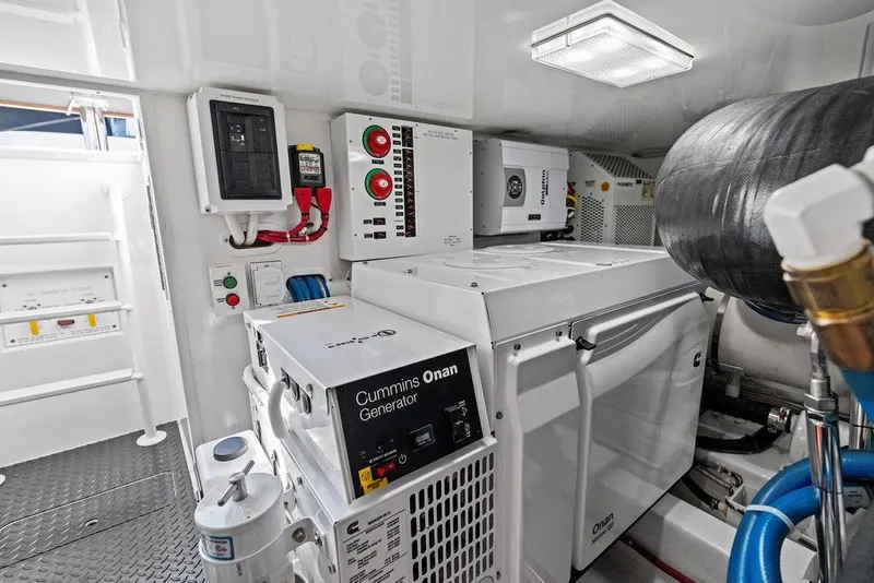 Slide: The Image of Engine room of 2022 Viking 48 Convertible with Cummins Onan generator and control panels. - 69