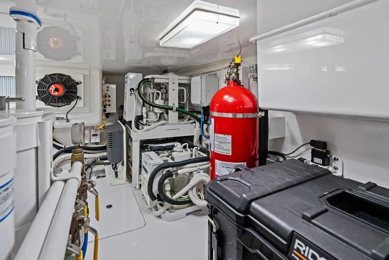 Slide: The Image of Engine room of 2022 Viking 48 Convertible yacht with fire extinguisher and equipment. - 73