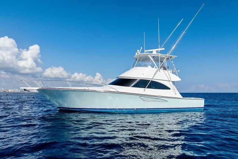 Slide: The Image of 2022 Viking 48 Convertible yacht on open sea under clear blue sky. - 8