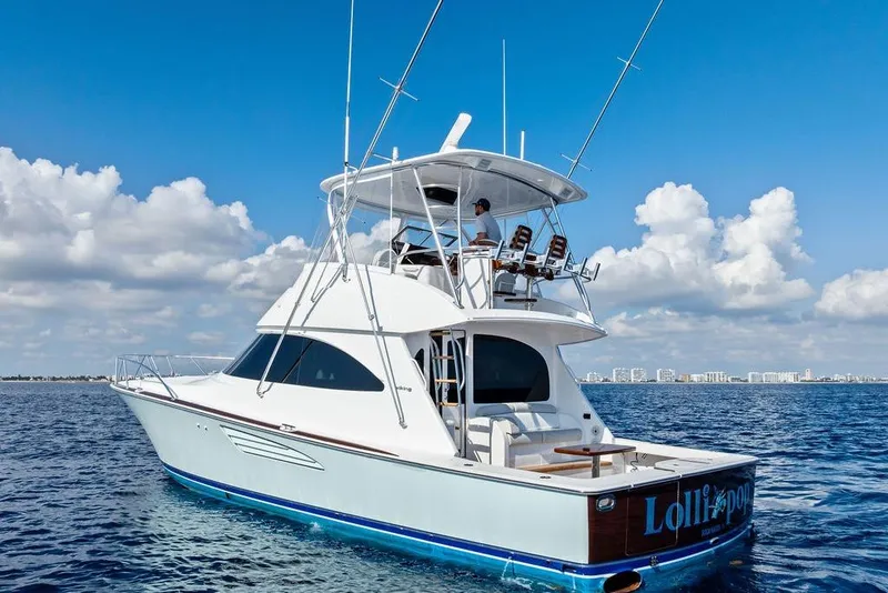 Slide: The Image of 2022 Viking 48 Convertible yacht cruising on open water under a clear blue sky. - 9