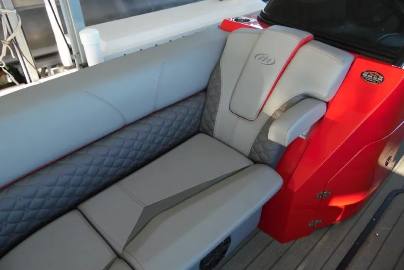 Slide: The Image of 2023 Manitou 25 XT RFX boat interior with gray and red seating. - 13
