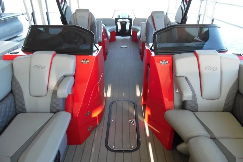 Slide: The Image of 2023 Manitou 25 XT RFX boat interior with red and gray seating. - 14