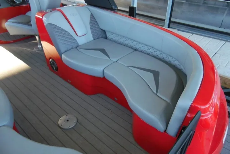 Slide: The Image of Luxurious seating on 2023 Manitou 25 XT RFX boat with red and gray upholstery. - 20