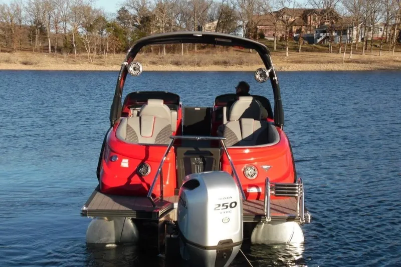 Slide: The Image of 2023 Manitou 25 XT RFX pontoon boat on a lake with Honda 250 VTEC engine. - 4
