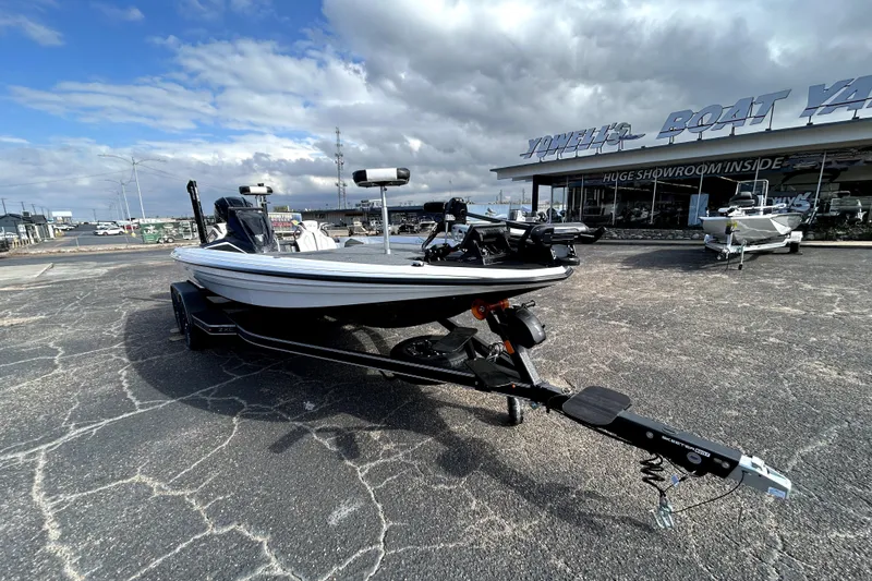 Slide: The Image of 2026 Skeeter ZXE20 boat on trailer at dealership under cloudy sky. - 1
