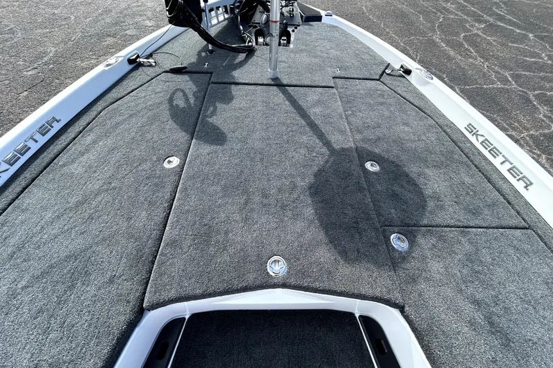 Slide: The Image of 2026 Skeeter ZXE20 boat deck with gray carpet and storage compartments. - 11