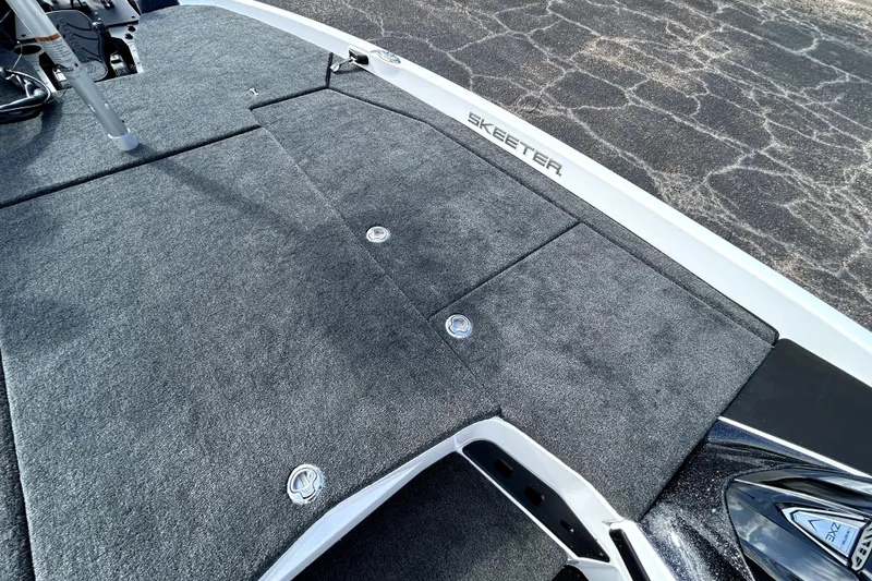 Slide: The Image of 2026 Skeeter ZXE20 boat deck with gray carpet and storage compartments. - 13