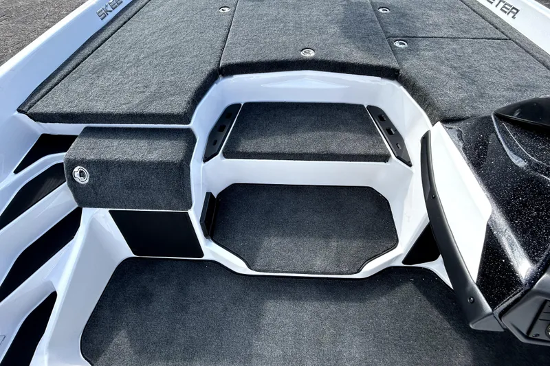 Slide: The Image of 2026 Skeeter ZXE20 boat interior with carpeted deck and storage compartments. - 17