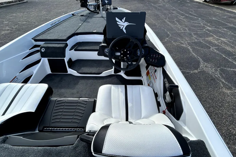 Slide: The Image of 2026 Skeeter ZXE20 boat interior with steering wheel and seating, showcasing modern design. - 32
