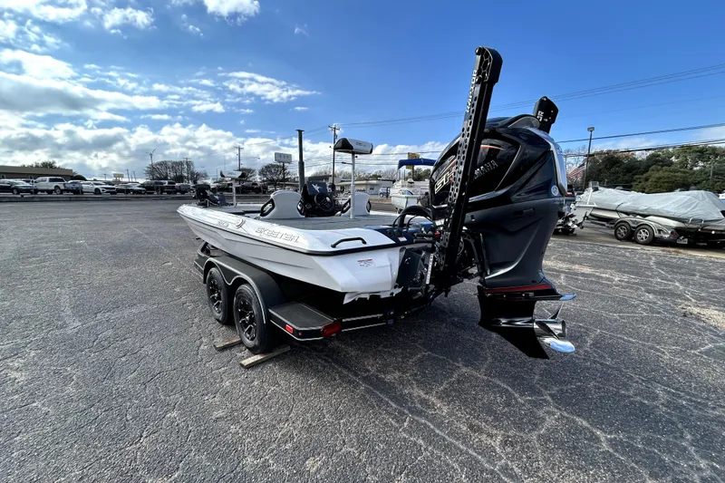 Slide: The Image of 2026 Skeeter ZXE20 boat with powerful outboard motor in a parking lot. - 4