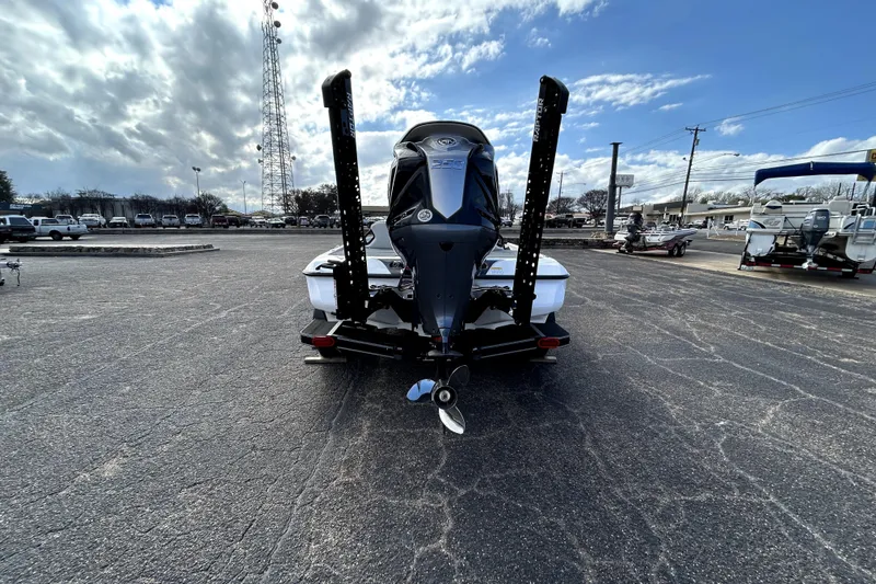 Slide: The Image of 2026 Skeeter ZXE20 boat rear view in parking lot under cloudy sky. - 5