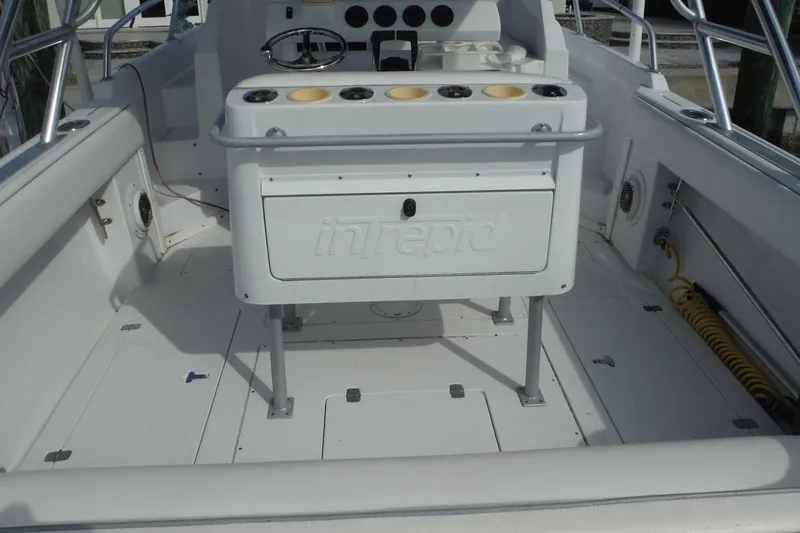 Slide: The Image of 1999 Intrepid 289 Center Console boat interior with seating and storage. - 10
