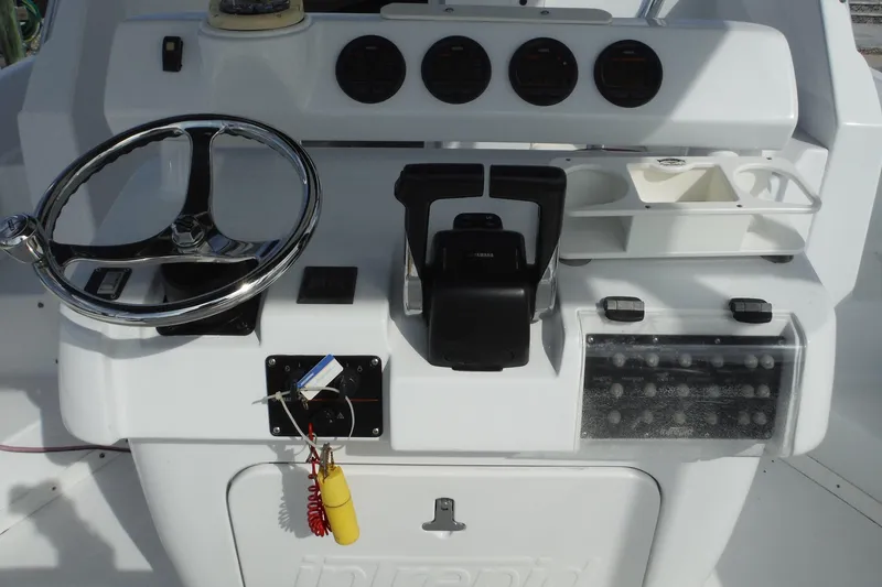 Slide: The Image of 1999 Intrepid 289 Center Console boat dashboard with steering wheel and controls. - 11