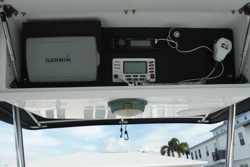 Slide: The Image of 1999 Intrepid 289 Center Console boat electronics, featuring Garmin navigation and communication equipment. - 12