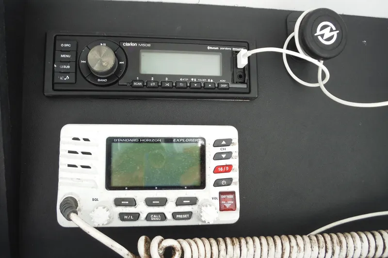 Slide: The Image of 1999 Intrepid 289 Center Console dashboard with Clarion radio and Standard Horizon Explorer. - 14