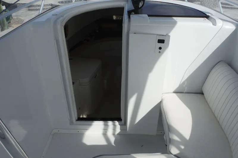 Slide: The Image of 1999 Intrepid 289 Center Console interior with seating and cabin entrance. - 15