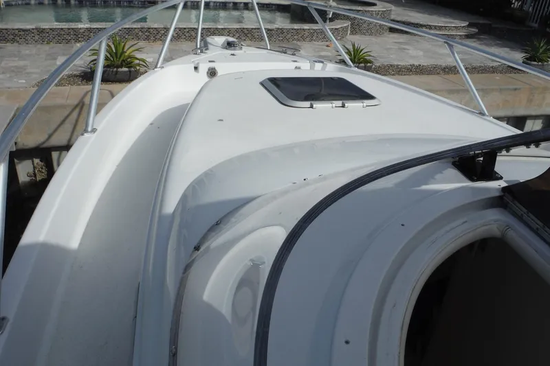 Slide: The Image of 1999 Intrepid 289 Center Console boat deck with railing and hatch. - 16