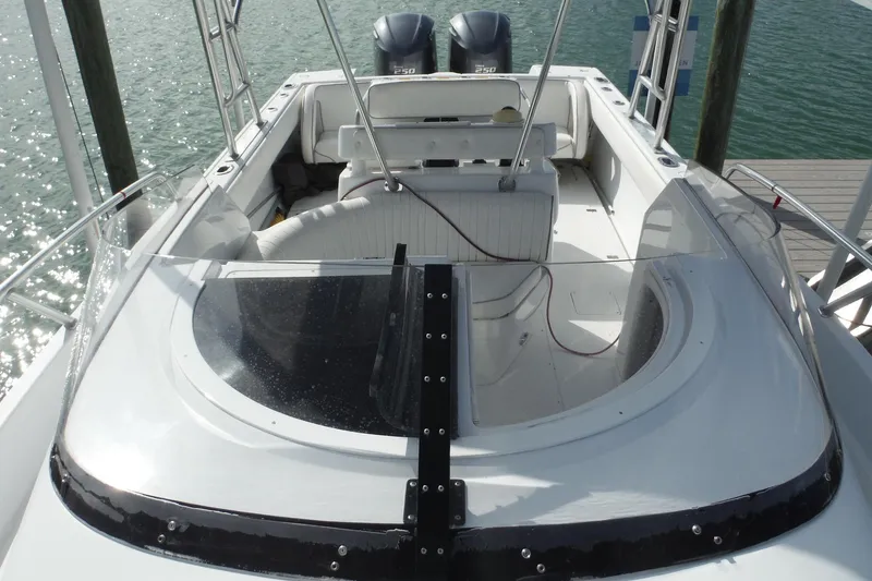 Slide: The Image of 1999 Intrepid 289 Center Console boat with dual engines, docked on a sunny day. - 19