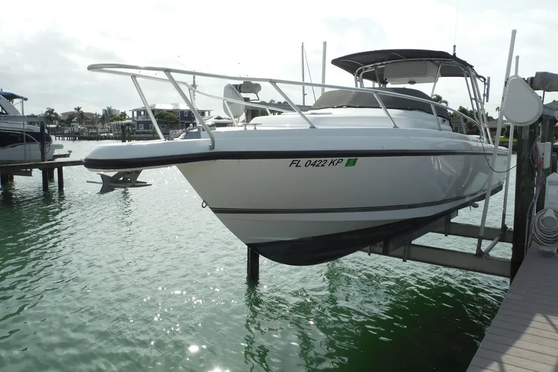Slide: The Image of 1999 Intrepid 289 Center Console boat docked on a lift in a marina. - 2