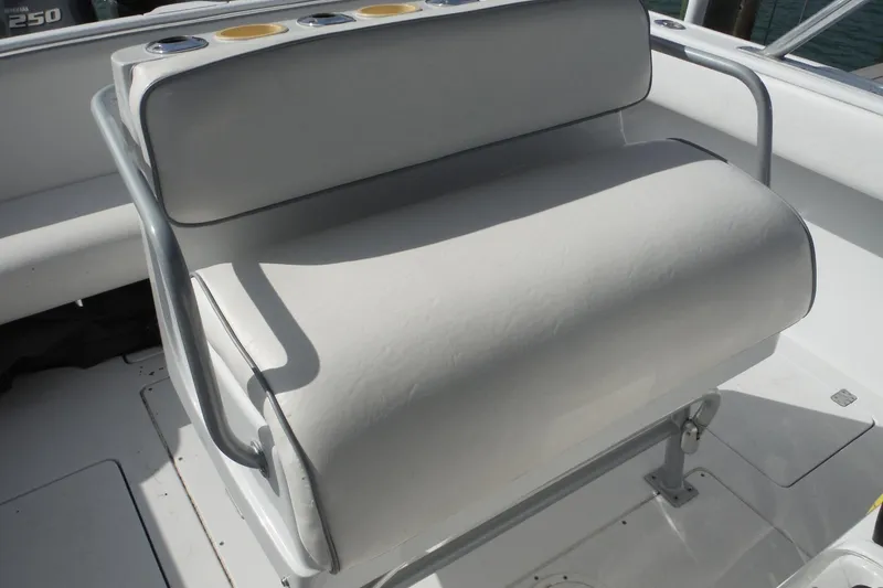 Slide: The Image of 1999 Intrepid 289 Center Console boat seat with cup holders. - 22