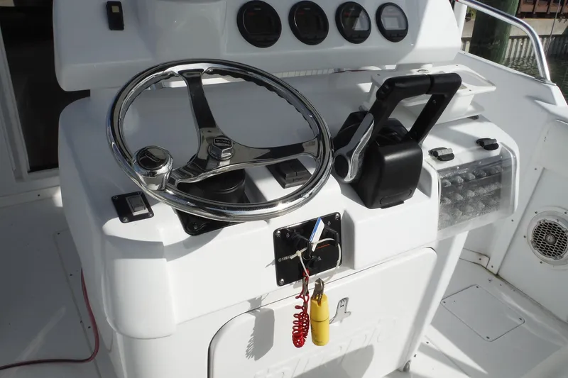 Slide: The Image of 1999 Intrepid 289 Center Console helm with steering wheel and controls. - 23