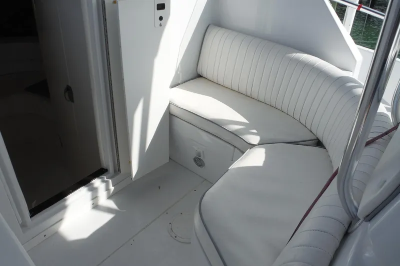 Slide: The Image of 1999 Intrepid 289 Center Console boat interior with white cushioned seating. - 24
