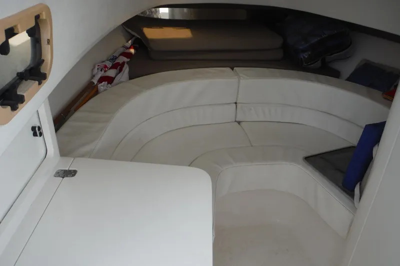 Slide: The Image of 1999 Intrepid 289 Center Console cabin interior with white seating and storage. - 25