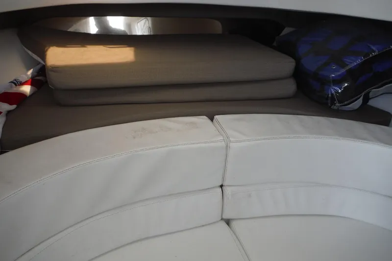 Slide: The Image of Interior seating area of a 1999 Intrepid 289 Center Console boat with cushions. - 26