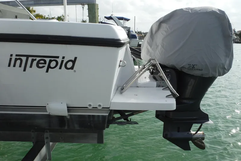 Slide: The Image of 1999 Intrepid 289 Center Console boat with covered outboard motor on water. - 3