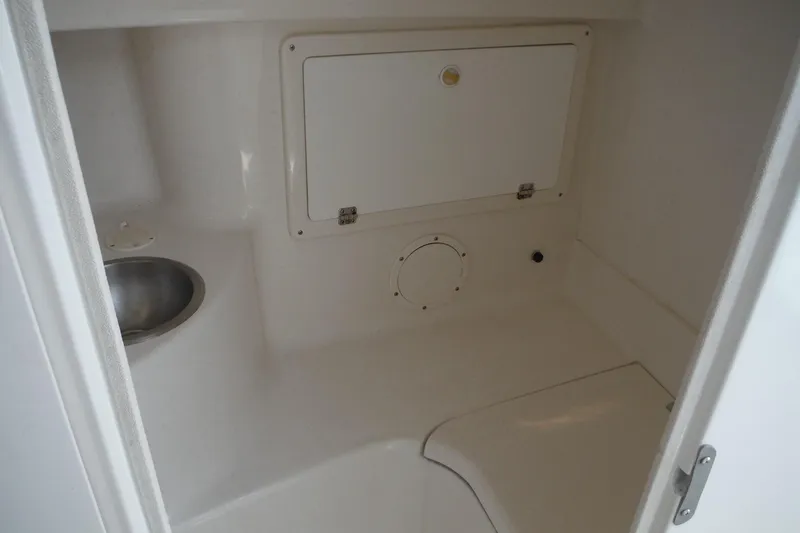 Slide: The Image of 1999 Intrepid 289 Center Console interior with sink and storage compartment. - 30