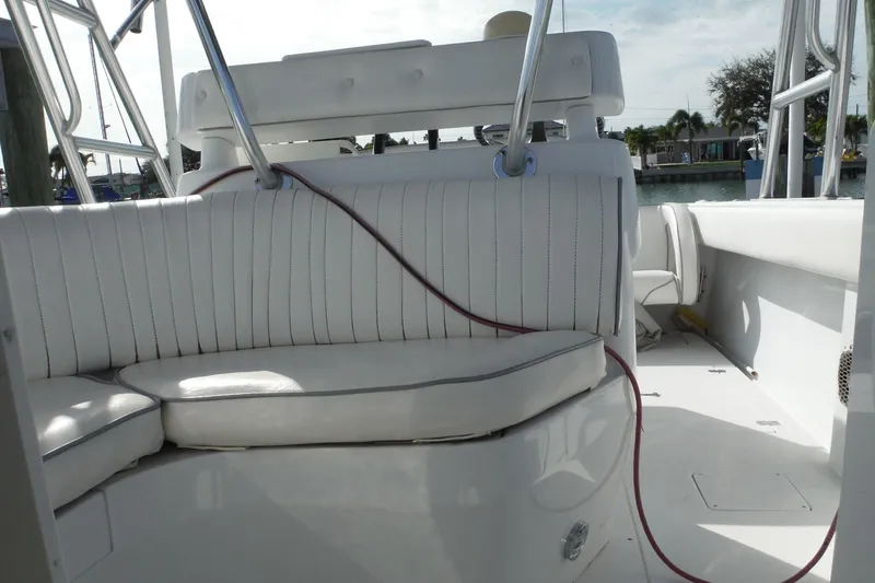 Slide: The Image of 1999 Intrepid 289 Center Console boat interior with white seating and metal railings. - 31
