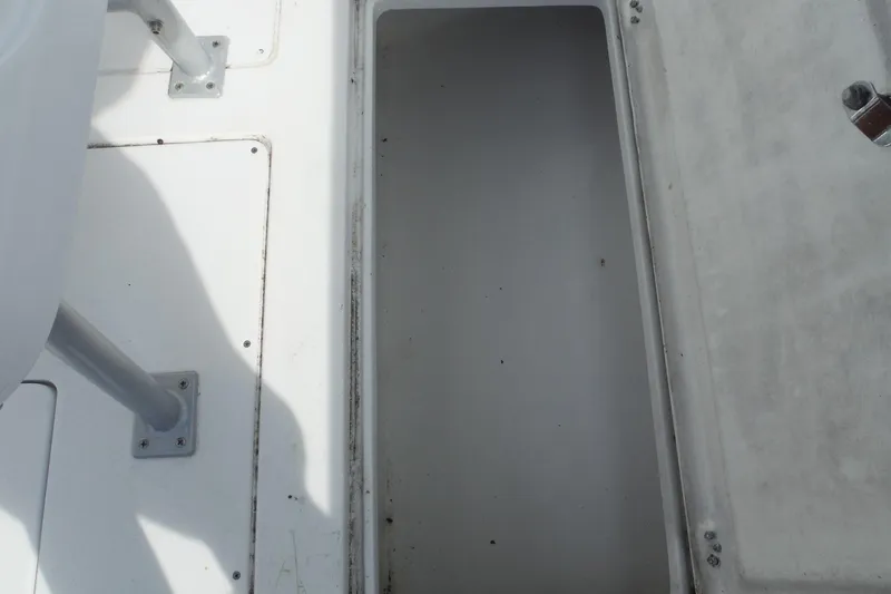 Slide: The Image of Open storage compartment on 1999 Intrepid 289 Center Console boat. - 38
