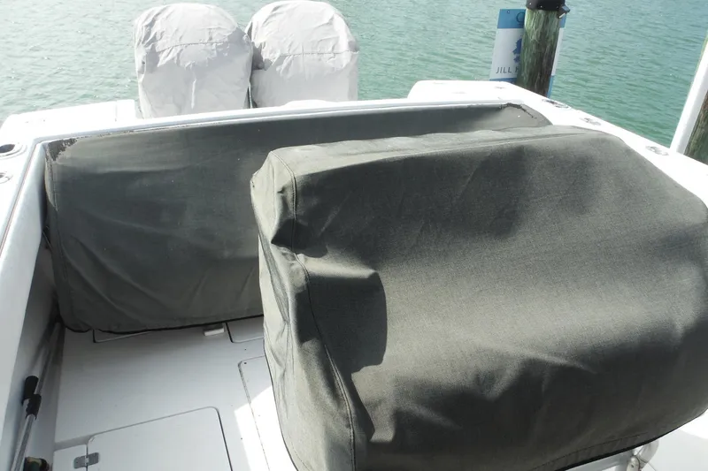 Slide: The Image of 1999 Intrepid 289 Center Console boat with covered engines at dock. - 4