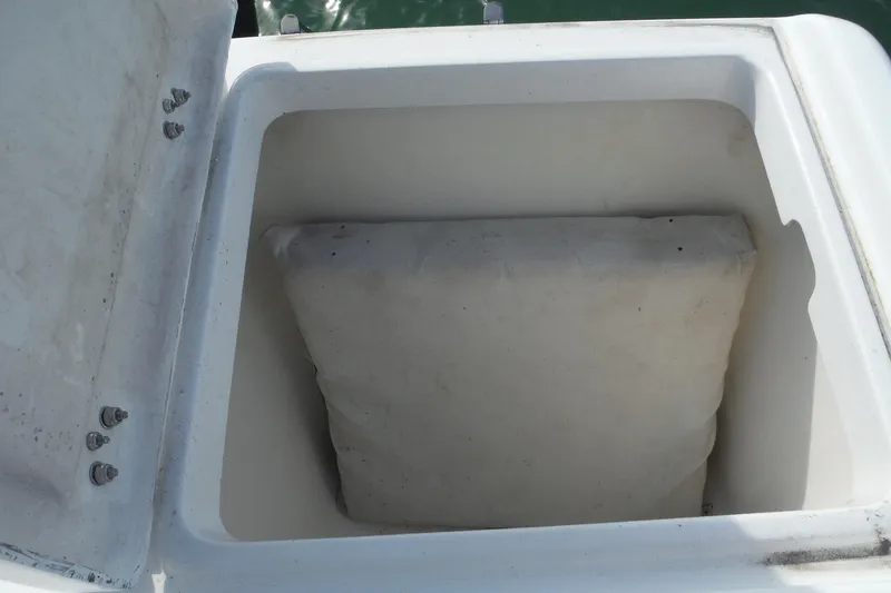 Slide: The Image of Open storage compartment on 1999 Intrepid 289 Center Console boat. - 40