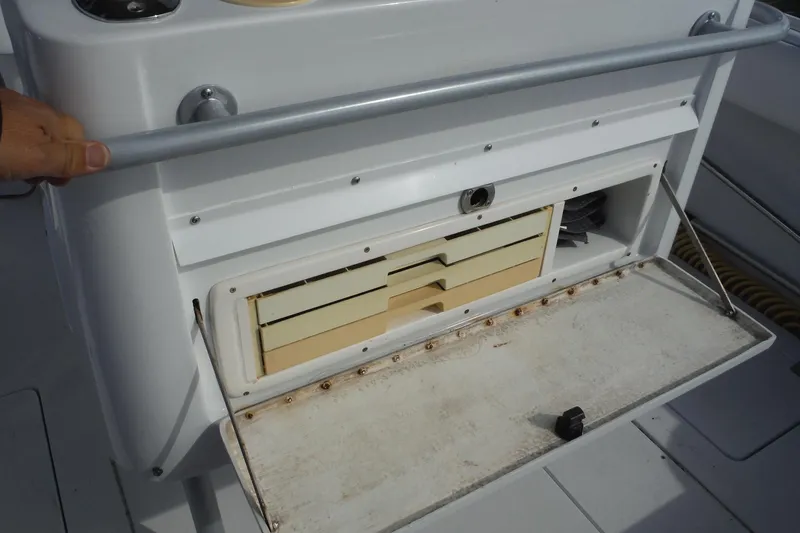 Slide: The Image of Open storage compartment on a 1999 Intrepid 289 Center Console boat. - 41