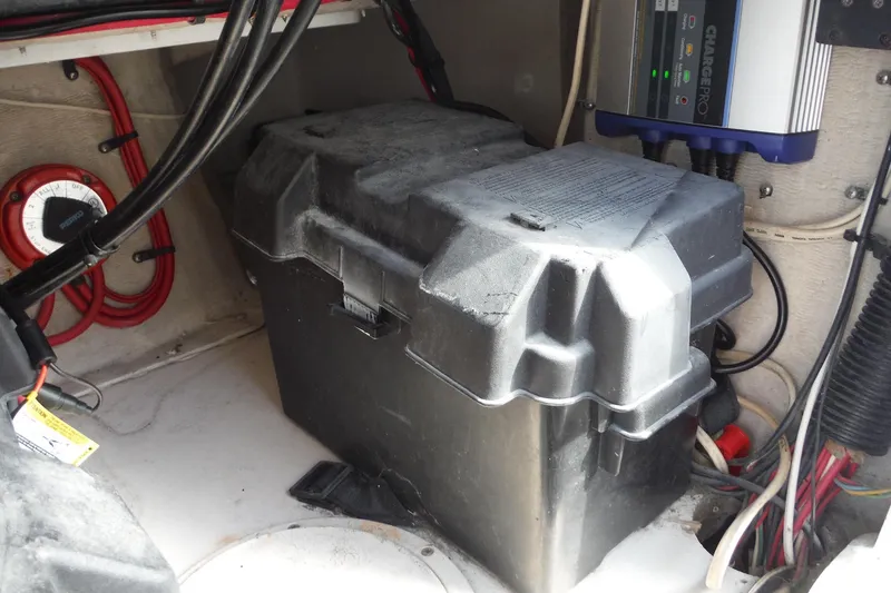Slide: The Image of Battery compartment of a 1999 Intrepid 289 Center Console boat with wiring and charger. - 42